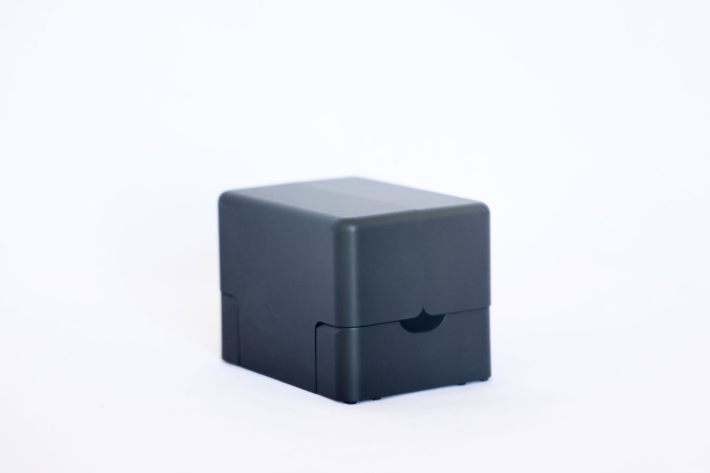 Closed matte black Lotus card shuffler, a compact rounded cube