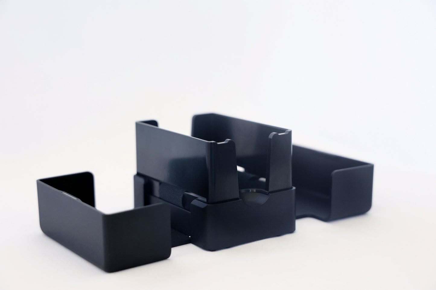 The Lotus card shuffler with its trays separated, showing how it comes apart