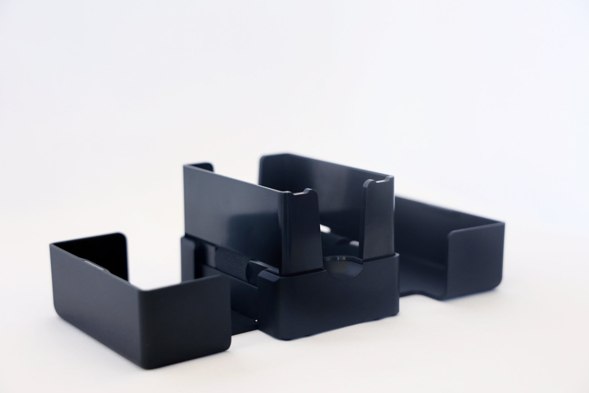 The Lotus card shuffler with its trays separated, showing how it comes apart