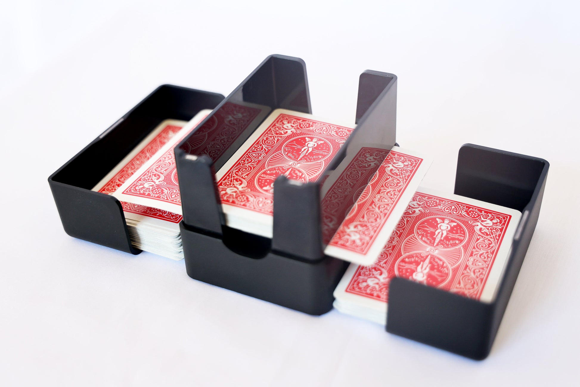 Lotus card shuffler with a red deck split into its two side trays