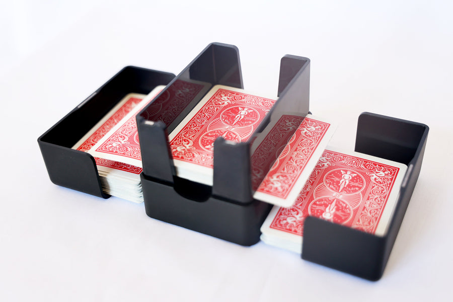 Lotus card shuffler with a red deck split into its two side trays